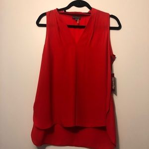 Red sleeveless blouse by Vince Camuto